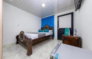 a bedroom with two beds and a mirror at Hotel Vegas Sergio in Medellín