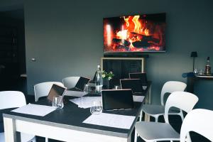 a meeting room with a table with chairs and a fireplace at Residence Nonna Mariuccia in Mazara del Vallo