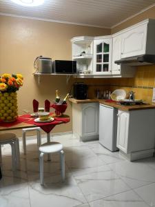 a kitchen with white cabinets and a table and chairs at Aimée - Loft in Sanary-sur-Mer +24 photos