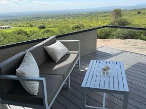 a couch and a table on a balcony at Escapada romántica en El Leon in San Javier +8 photos