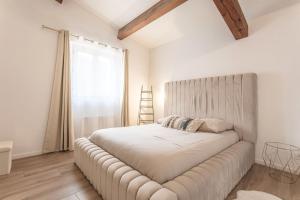 a bedroom with a large bed with a large window at Charmante Villa Necsilia in Solliès-Toucas +23 photos