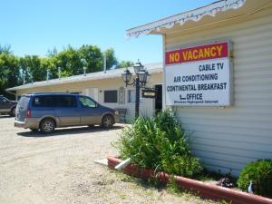 a van parked outside of a building with a no vacancy sign at Wakaw Lodge Motel in Wakaw