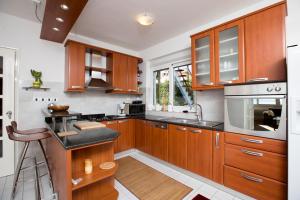 a kitchen with wooden cabinets and a counter top at Blue View Apartment in Opatija
