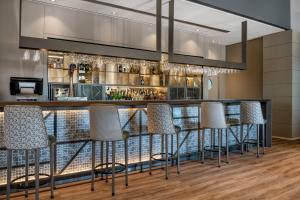 a bar with stools and a bar counter at AC Hotel A Coruña by Marriott in A Coruña