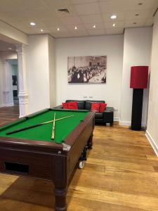 a room with a pool table and a couch at The Palace Hotel in Southend-on-Sea