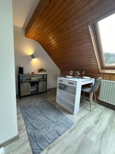 an attic room with a desk and a window at Blick auf den Rhein in Kestert