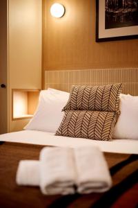 a bedroom with a bed with two towels on it at 6 VH Hotel in Paris