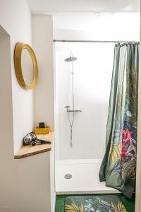a bathroom with a shower with a shower curtain at C'est Chouette le gîte ! in Saint-Jodard