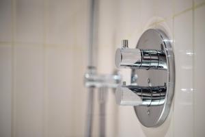 a chrome toilet paper dispenser in a bathroom at 6 VH Hotel in Paris