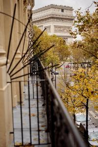 a view of the eiffel tower from a balcony of a building at 6 VH Hotel in Paris