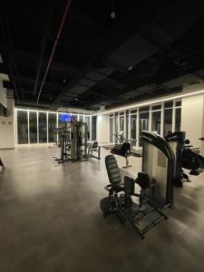 a gym with chairs and machines in a room at Apartamento Nuevo y Lujoso! in Mexico City