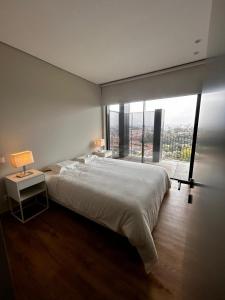 a bedroom with a large bed and a large window at New Douro 801 with parking in Vila Nova de Gaia +14 photos