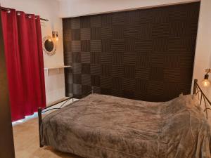 a bedroom with a bed and red curtains at Relaxrooms, 1 queen size bed, swimming pool in Agios Georgios