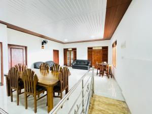 a dining room and living room with a table and chairs at Paradise Villa in Weligama