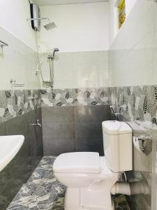a bathroom with a toilet and a sink and a shower at Paradise Villa in Weligama +20 photos
