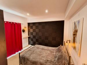 a bedroom with a bed and a red curtain at Relaxrooms, 1 queen size bed, swimming pool in Agios Georgios