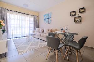 a living room with a table and a couch at Ridge Comfort in Midrand
