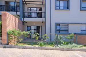 an apartment building with a fence in front of it at Ridge Comfort in Midrand