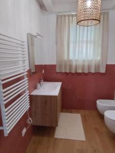 a bathroom with a sink and a toilet and a mirror at Agriturismo Frutti Antichi - Melograno in Fano