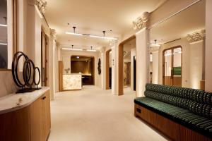 a hallway with a green bench in a building at 6 VH Hotel in Paris