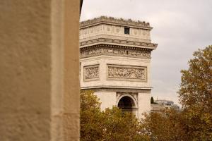 a tall white tower with a clock on it at 6 VH Hotel in Paris