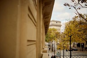 a view of a street with a building and trees at 6 VH Hotel in Paris