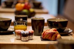 a table with bread and two glasses of orange juice at 6 VH Hotel in Paris