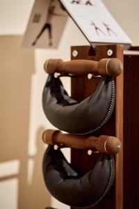 a group of belts on a wooden rack at 6 VH Hotel in Paris