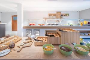 a kitchen with a table with boxes of food at Holiday Inn Bristol Airport by IHG in Redhill