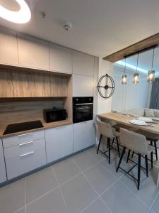 a kitchen with a table and a dining room at Amelie's Apartment 1 in Skopje