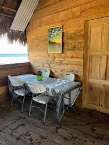 a dining room with a table and chairs at Buena Onda Surf House in León