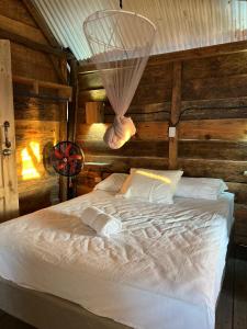 a bedroom with a bed in a room with wooden walls at Buena Onda Surf House in León