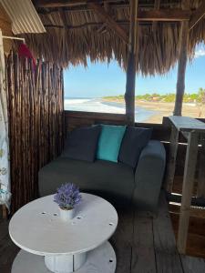 a living room with a couch and a table at Buena Onda Surf House in León +5 photos