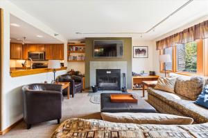 a living room with a couch and a fireplace at Highridge A16 Stunning Three Bedroom Condo with Whirlpool Bath, Heated Pool, and Game Room in Killington
