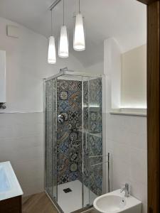 a bathroom with a shower and a toilet and a sink at Nolarium in Pescocostanzo +4 photos