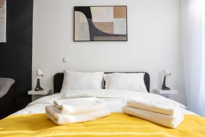 a bed with white towels on top of it at Studio Piaf City Break Nest in Belgrade