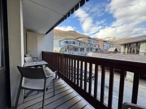 a balcony with chairs and a table and a view at RPP A115 - Skis aux pieds, 4 pers, 2 chambres in Tignes