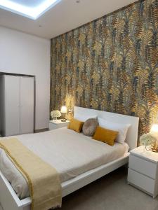 a bedroom with a large bed with a wall mural at Le FATE DI V E N E R E in Caserta