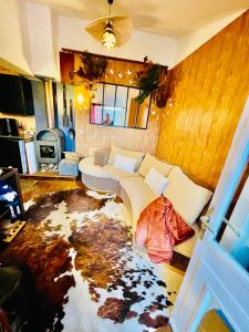 a living room with a couch and a large floor rug at Maison DonaSete T3 in Vieille-Brioude