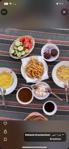 a table with plates of food and plates of food at Nuba Heart in Aswan +82 photos
