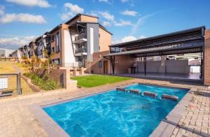 a large swimming pool in front of a building at Ridge Comfort in Midrand