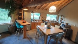 a kitchen with a wooden table and chairs at Nautilus Ecocasa Lago Puelo in Lago Puelo