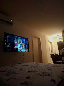 a bedroom with a bed and a tv on the wall at Apartman Doboj in Doboj +5 photos
