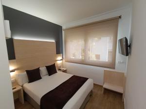 Posteľ alebo postele v izbe v ubytovaní Hotel Travessera