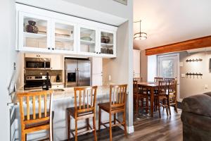 a kitchen and dining room with a table and chairs at Hidden Creek Canyons Retreat, Alpine Charm, Private Hot Tub, Sleeps 8, Cozy Fireplace, in Park City