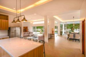 a kitchen and living room with a kitchen and a living room at Corner House in Tagaytay