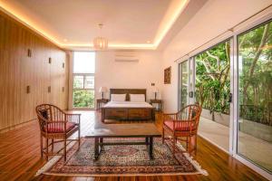 a room with a bed and a table and chairs at Corner House in Tagaytay