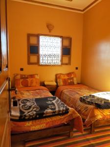 Postel nebo postele na pokoji v ubytování Riad Bouchahoud Hotel in Telouet