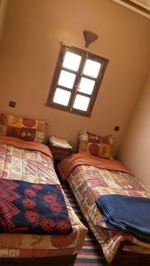 Postel nebo postele na pokoji v ubytování Riad Bouchahoud Hotel in Telouet