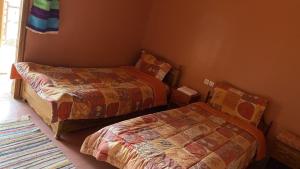 Postel nebo postele na pokoji v ubytování Riad Bouchahoud Hotel in Telouet
